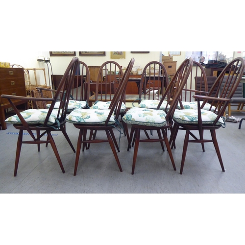 261 - A set of eight Ercol beech and elm framed spindled high hoop back dining chairs, raised on turned le... 