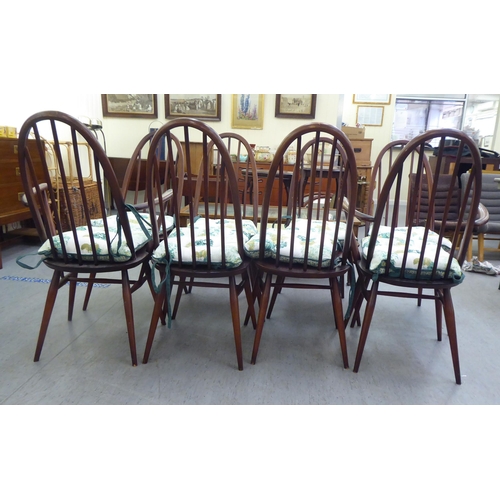 261 - A set of eight Ercol beech and elm framed spindled high hoop back dining chairs, raised on turned le... 