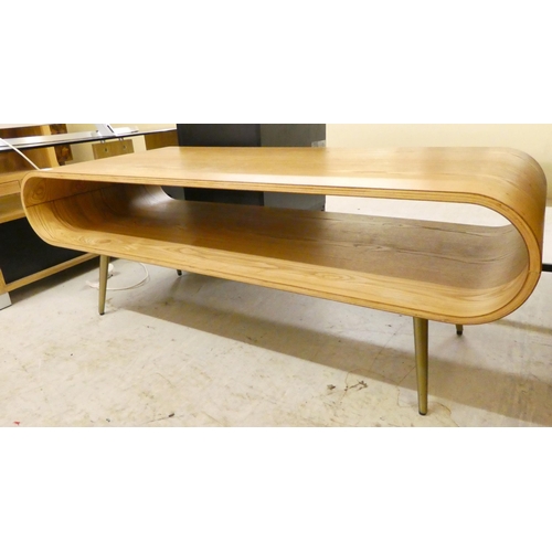 27 - A modern curved pine effect coffee table, raised on tapered legs  17