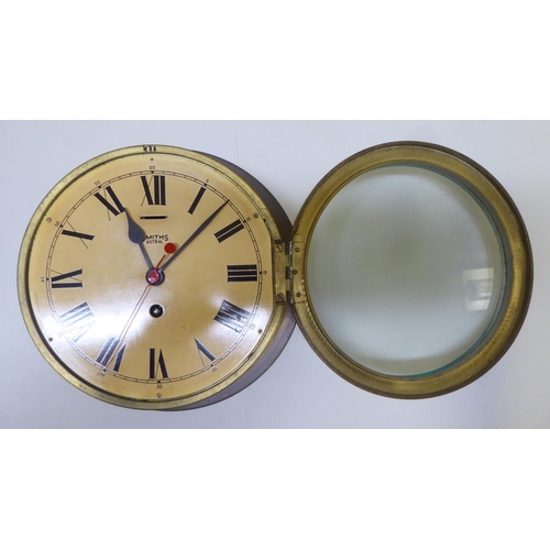 275 - Two Smiths Astral brass cased bulkhead timepieces with painted Roman dials, one mounted on a plaque ... 