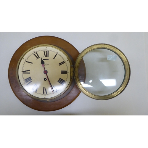 275 - Two Smiths Astral brass cased bulkhead timepieces with painted Roman dials, one mounted on a plaque ... 