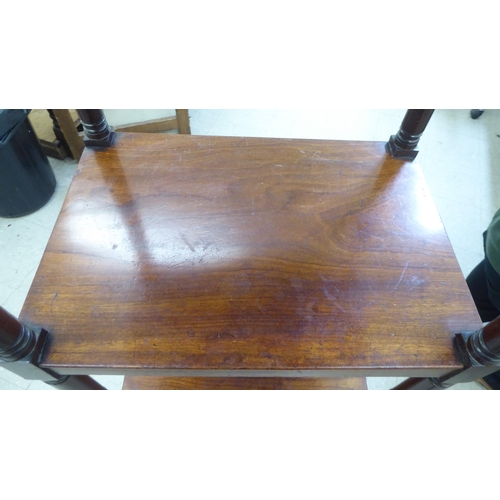 282 - A George III mahogany four tier what-not, on ring turned supports, incorporating a hinged top and a ... 