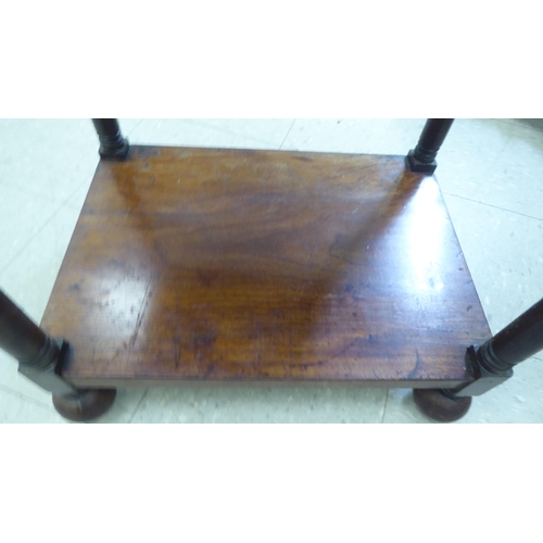 282 - A George III mahogany four tier what-not, on ring turned supports, incorporating a hinged top and a ... 