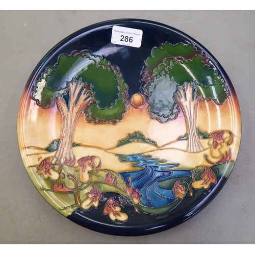 286 - A Moorcroft pottery plate 'Evening Sky'  designed by Emma Bossons, decorated in colours and tubeline... 