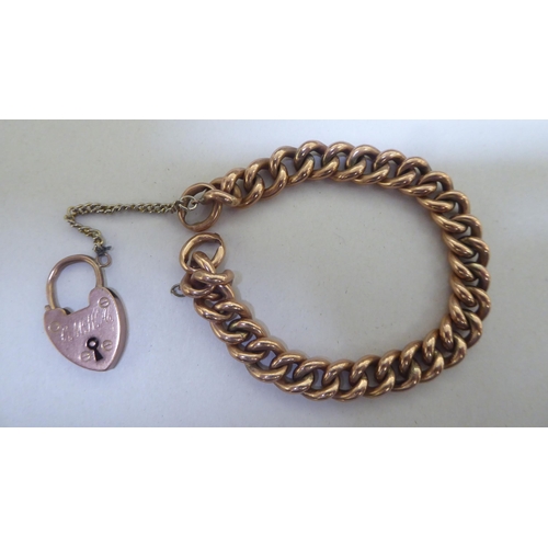 295 - A 9ct gold bracelet with a heart shaped padlock clasp 