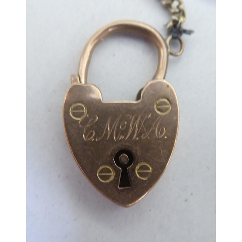 295 - A 9ct gold bracelet with a heart shaped padlock clasp 