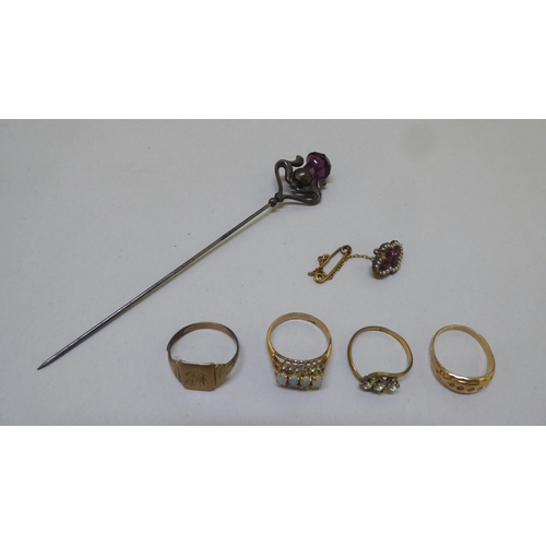 298 - Items of personal ornament: to include a hatpin; and a yellow metal ring 