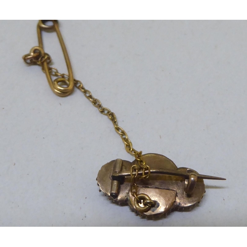 298 - Items of personal ornament: to include a hatpin; and a yellow metal ring 