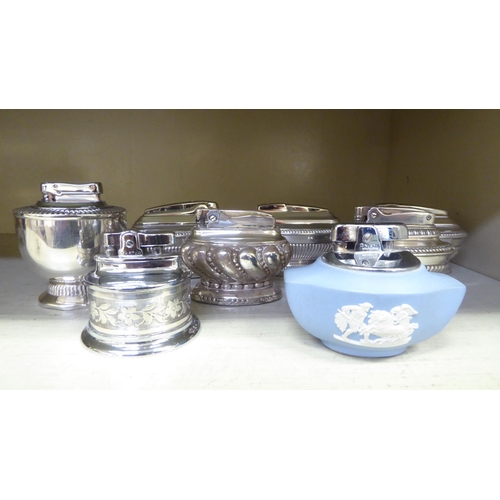 314 - Seven silver plated table lighters, one in powder blue Wedgwood jasperware, some by Ronson 