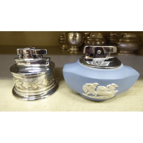 314 - Seven silver plated table lighters, one in powder blue Wedgwood jasperware, some by Ronson 