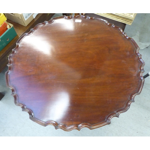 46 - A late Victorian mahogany tip-top pedestal table, raised on a tripod base with carved cabriole legs ... 