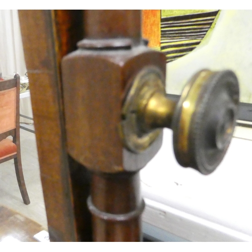62 - A Regency mahogany toilet mirror, pivoting on turned horns, on a box base with three drawers  25