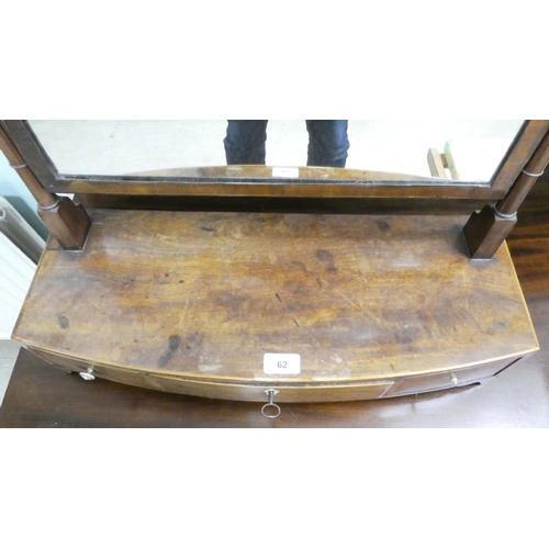 62 - A Regency mahogany toilet mirror, pivoting on turned horns, on a box base with three drawers  25