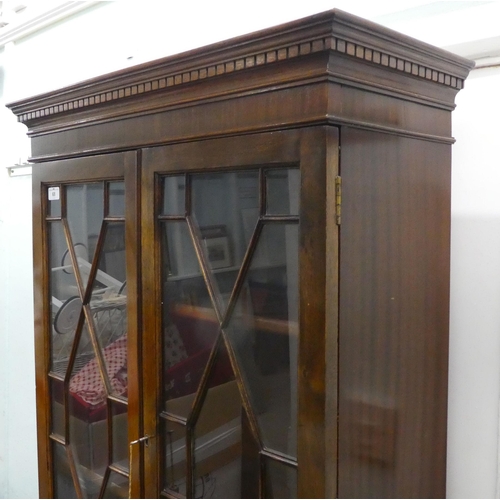 68 - A modern crossbanded mahogany bureau bookcase, raised on bracket feet&nbsp; 79