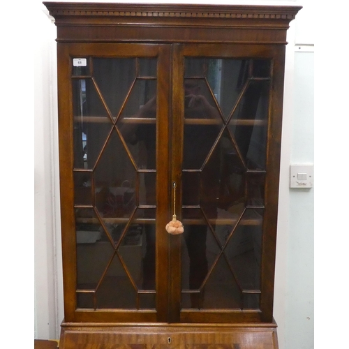68 - A modern crossbanded mahogany bureau bookcase, raised on bracket feet&nbsp; 79