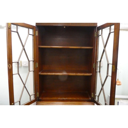 68 - A modern crossbanded mahogany bureau bookcase, raised on bracket feet&nbsp; 79