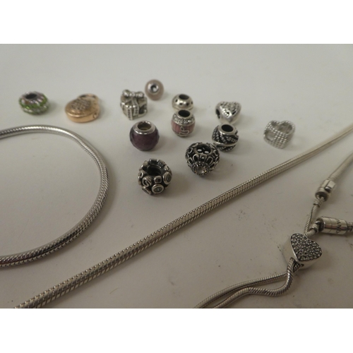 77 - A silver Pandora bracelet; and associated charms