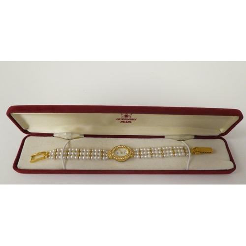 82 - Three ladies Guernsey gold plated and steel cased wristwatches, each pearl set   two boxed