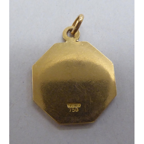 248 - An 18ct gold pendant, decorated with a pair of fish, amidst stars  stamped 750