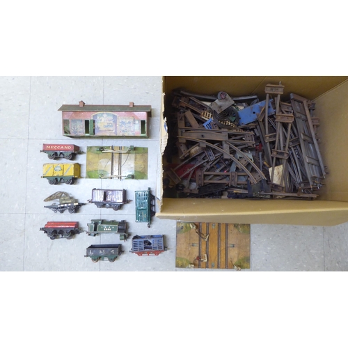 308 - Model railway related items by Hornby: to include track, tinplate buildings and rolling stock