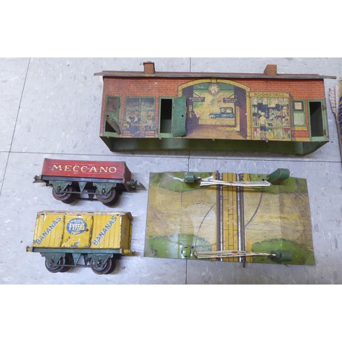 308 - Model railway related items by Hornby: to include track, tinplate buildings and rolling stock