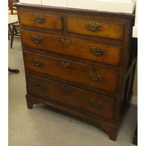 113 - An 18thC country made oak dressing chest, the planked top over two short/three graduated long drawer... 