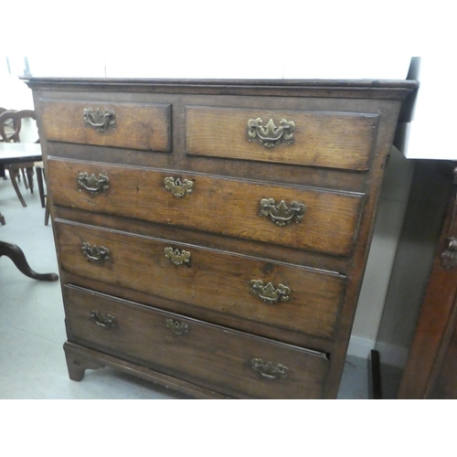 113 - An 18thC country made oak dressing chest, the planked top over two short/three graduated long drawer... 