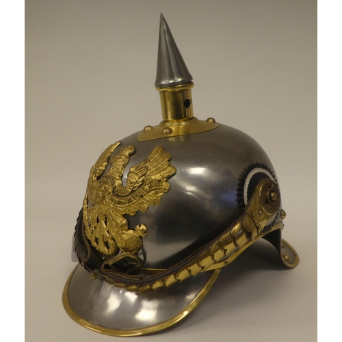 121 - A German polished steel and brass mounted pickelhaube with a liner(Please Note: this lot is subject ... 