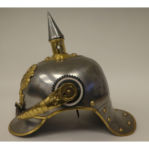 121 - A German polished steel and brass mounted pickelhaube with a liner(Please Note: this lot is subject ... 