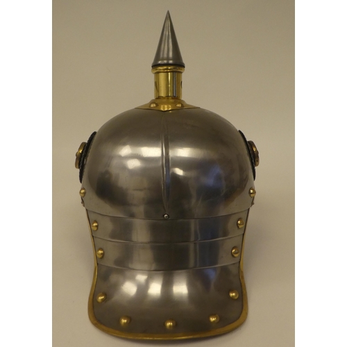 121 - A German polished steel and brass mounted pickelhaube with a liner(Please Note: this lot is subject ... 