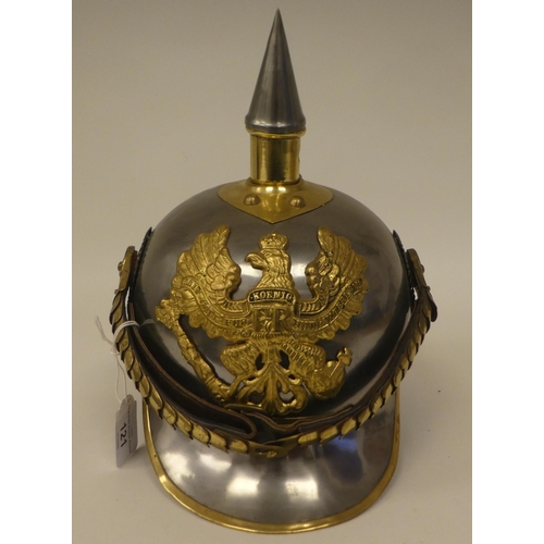 121 - A German polished steel and brass mounted pickelhaube with a liner(Please Note: this lot is subject ... 