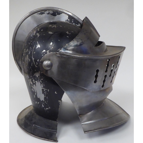 124 - Re-enactment armour, viz. a knight's helmet incorporating a visor; a breastplate with buckled straps... 