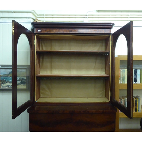 169 - A mid Victorian mahogany cabinet bookcase with a straight cornice, over a pair of glazed doors, encl... 