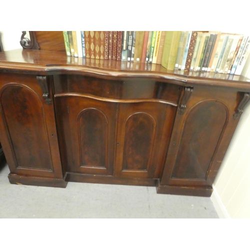 172 - A mid Victorian mahogany inverted breakfront sideboard with a carved, D-shaped upstand, over a centr... 