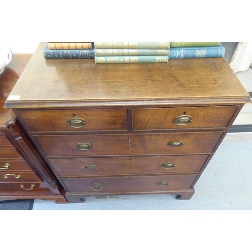 176 - A 19thC oak dressing chest with two short/three graduated long drawers and brass bail handles, raise... 