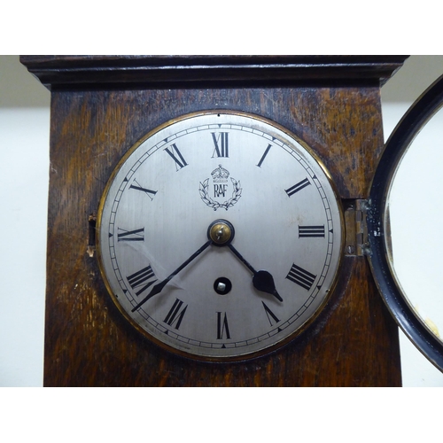 187 - A 1920s oak cased mantel clock; the movement faced by a Roman dial with an RAF emblem  14