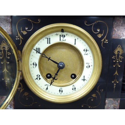 191 - A late Victorian slate and marble cased mantel clock of architectural form; the movement faced by an... 