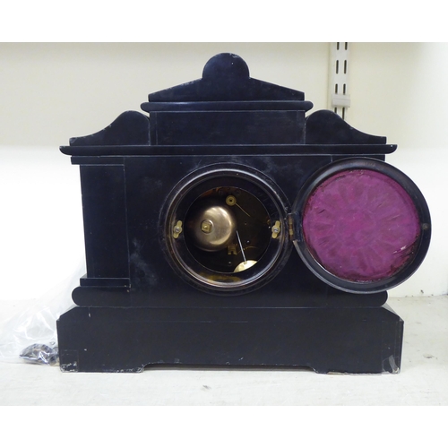 191 - A late Victorian slate and marble cased mantel clock of architectural form; the movement faced by an... 