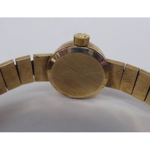 199 - A ladies Omega 9ct gold cased bracelet wristwatch, faced by a baton dial