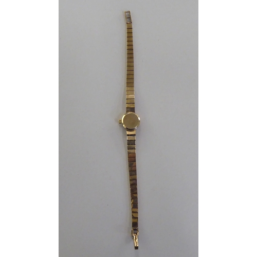 199 - A ladies Omega 9ct gold cased bracelet wristwatch, faced by a baton dial