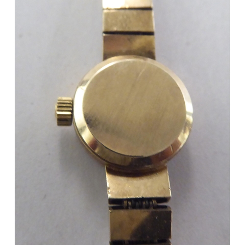 199 - A ladies Omega 9ct gold cased bracelet wristwatch, faced by a baton dial