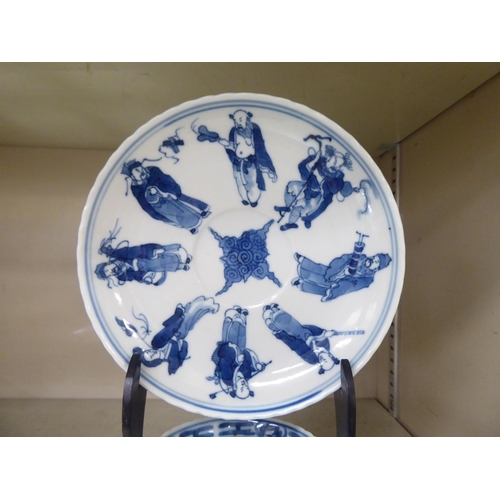 203 - An 18thC Chinese porcelain cup and saucer, decorated with figures, in blue and white, bearing a four... 