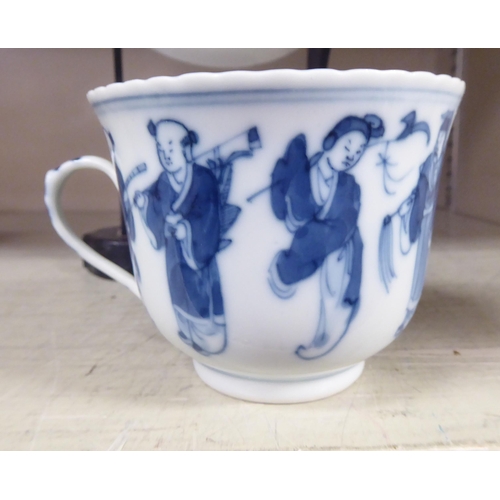 203 - An 18thC Chinese porcelain cup and saucer, decorated with figures, in blue and white, bearing a four... 