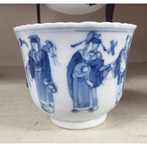 203 - An 18thC Chinese porcelain cup and saucer, decorated with figures, in blue and white, bearing a four... 