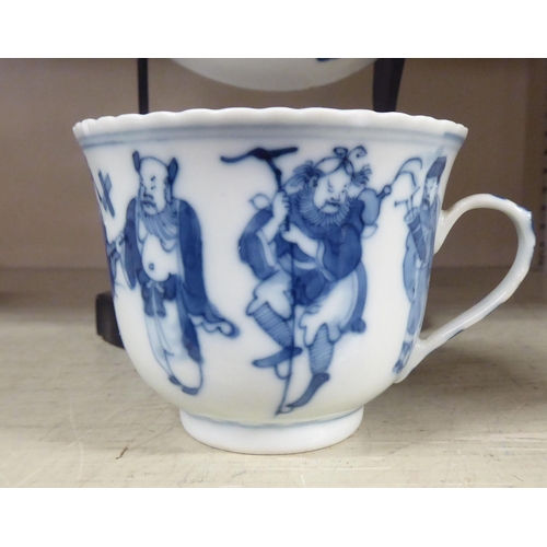 203 - An 18thC Chinese porcelain cup and saucer, decorated with figures, in blue and white, bearing a four... 