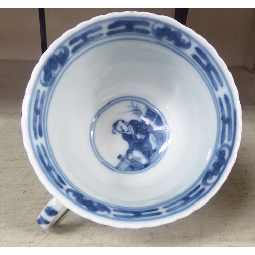 203 - An 18thC Chinese porcelain cup and saucer, decorated with figures, in blue and white, bearing a four... 