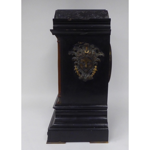 21 - A late Victorian black slate cased mantel clock with applied, decoratively cast mounts and blue and ... 