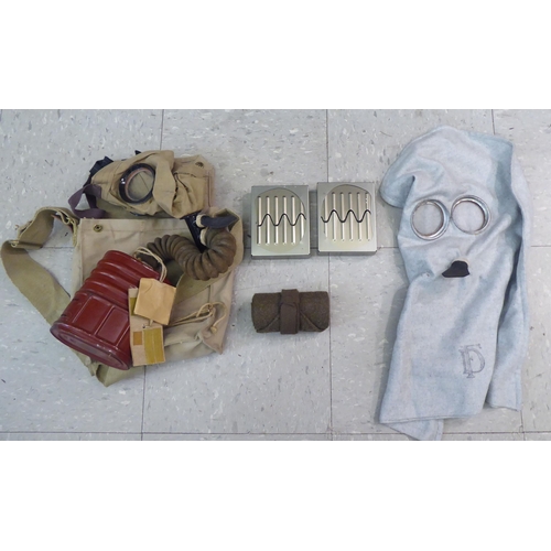 230 - Military related items: to include a first aid box; an ammunition carrier and a gas mask holder ... 