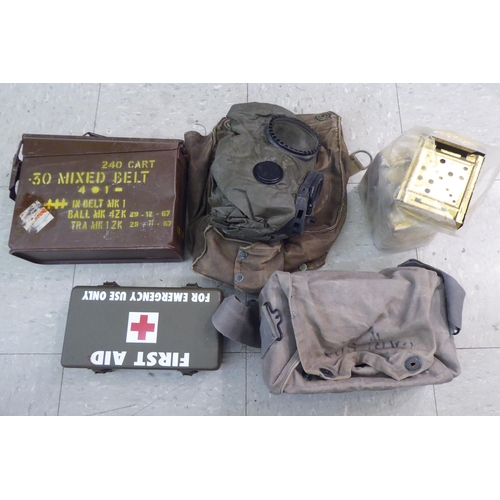 230 - Military related items: to include a first aid box; an ammunition carrier and a gas mask holder ... 