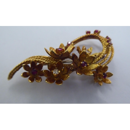 232 - A yellow metal floral spray design brooch, set with diamonds and rubies